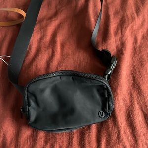 Two Lululemon Belt Bags - Black and White Opal